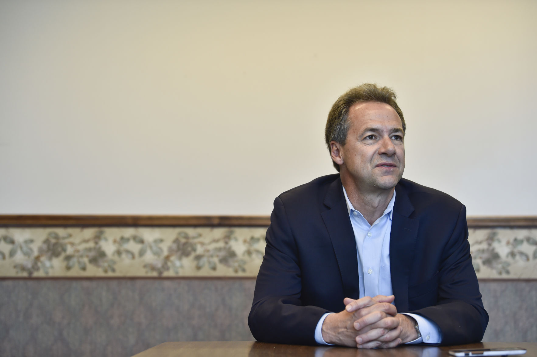 Gov. Steve Bullock talks with a reporter